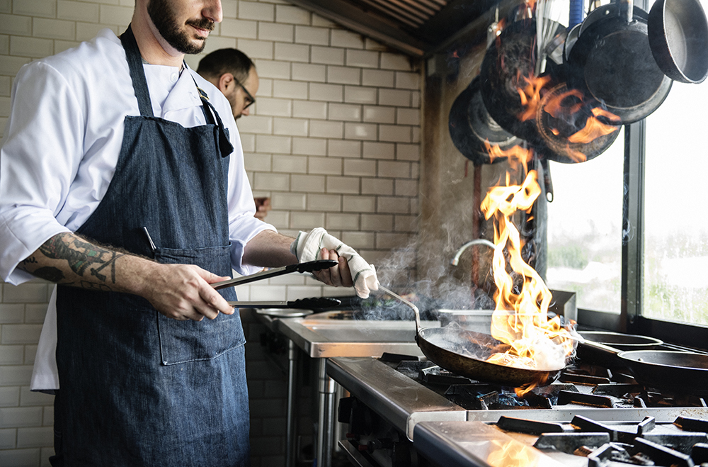 Chef cooking food in restaurant fire